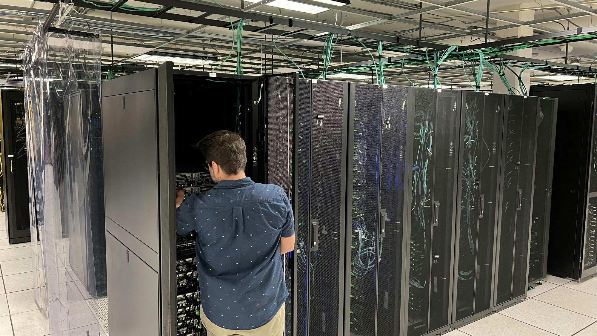 Nathan Elger, an architect for Hyperion, looks inside one section of the machine, April 28,2022.