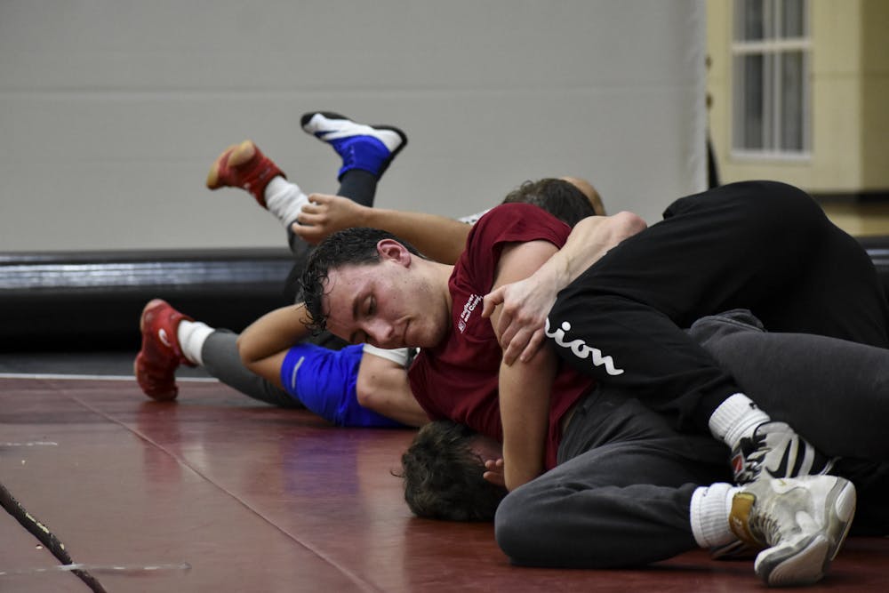 <p>Members of the University of South Carolina's club wrestling team work on making pins during their practice at Strom Thurmond Wellness and Fitness Center on Feb. 1, 2023. The wrestling team practices on Mondays and Wednesdays to prepare for tournaments.&nbsp;</p>