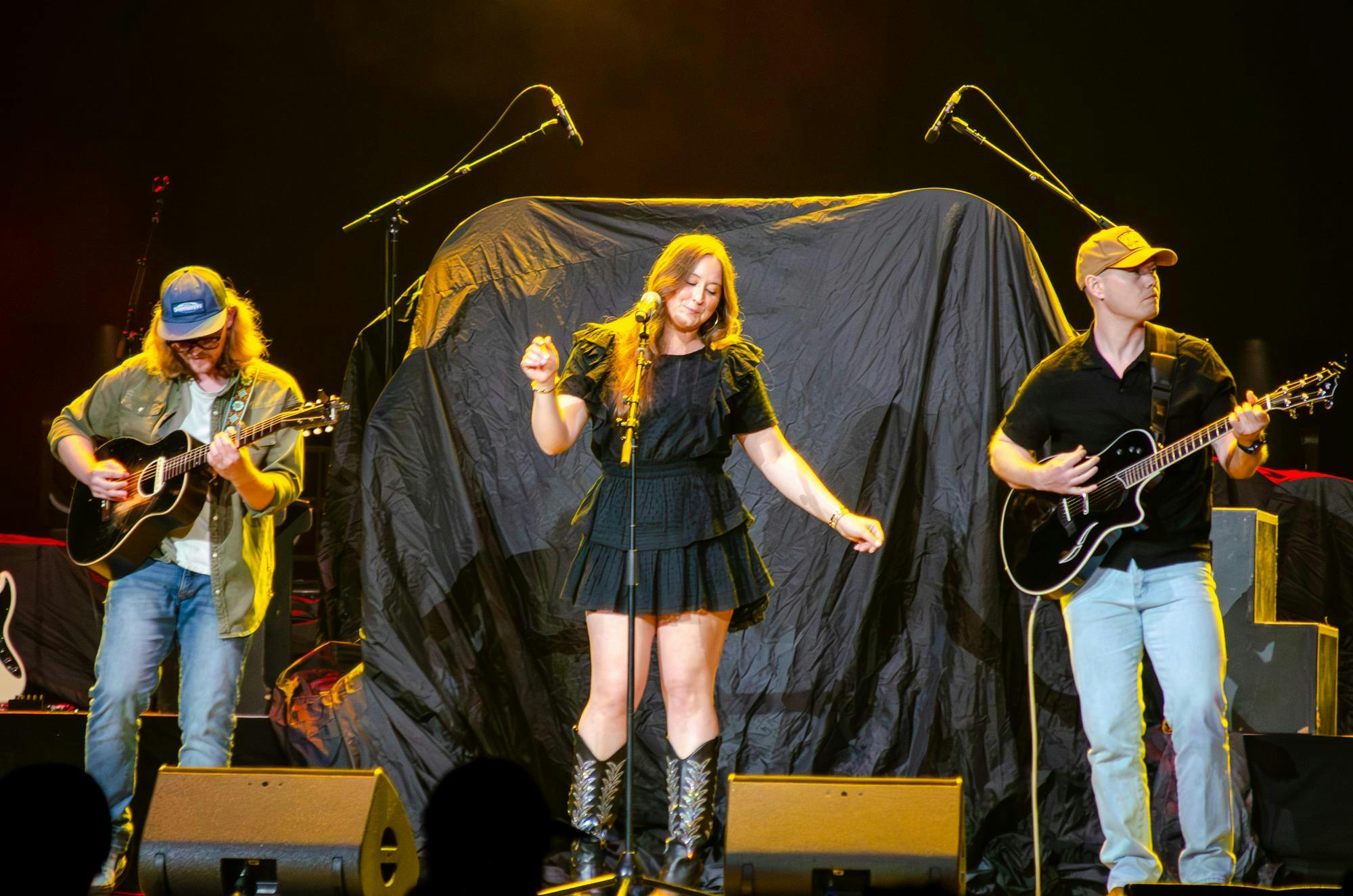 Mary English dances during her opening for Lauren Alaina and Darius Rucker at the Garnet &amp; Black Spring Fest in Columbia, South Carolina, on April 11, 2026. There, she sang an original song about USC.