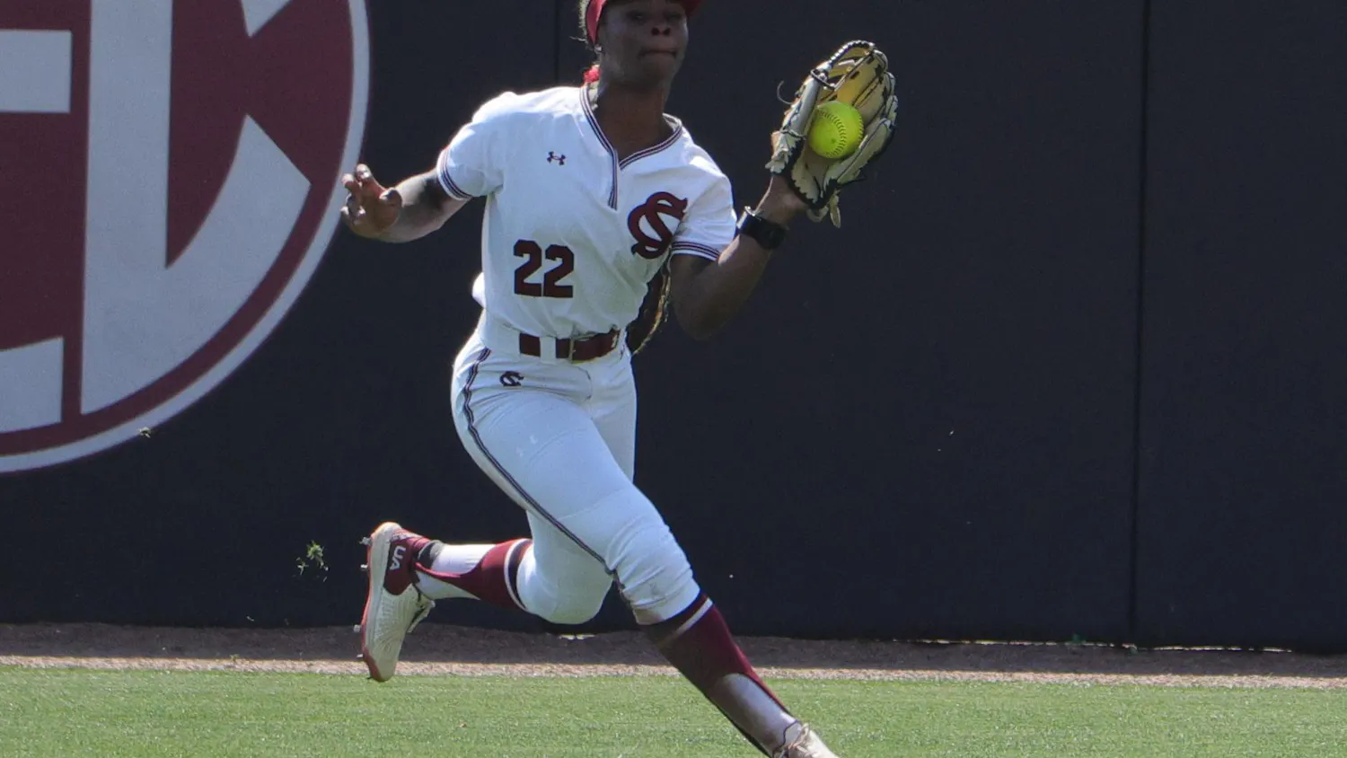 Sophomore outfielder Nia McKnight tracks down a fly ball in the outfield against LSU at Carolina Softball Stadium at Beckham Field in Columbia, South Carolina, on March 22, 2026. McKnight secures the catch while moving toward the wall.