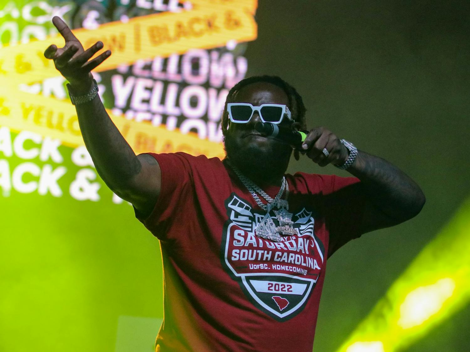 T-Pain performing at Cockstock on Oct. 21, 2022. With black and yellow lighting and background projected behind him, the set matched his performance of “Black and Yellow." 