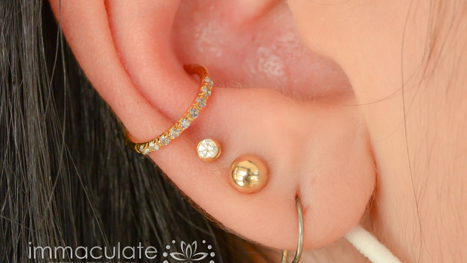 A customer displays their intricate ear design after being pierced and styled at Immaculate Body Piercing. Founder and owner Sarah Wooten prioritizes the safety and comfort of her clients when visiting her shop.