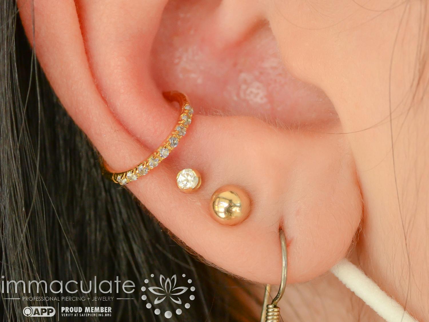 A customer displays their intricate ear design after being pierced and styled at Immaculate Body Piercing. Founder and owner Sarah Wooten prioritizes the safety and comfort of her clients when visiting her shop.