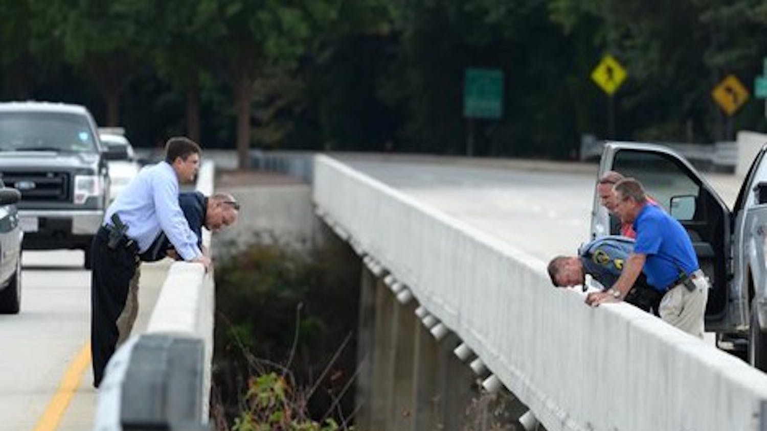 Investigators look over the bridge on State 93 over the Seneca River in Clemson Tuesday, September 23, 2014 where the body of Clemson student Tucker W. Hipps was found yesterday.