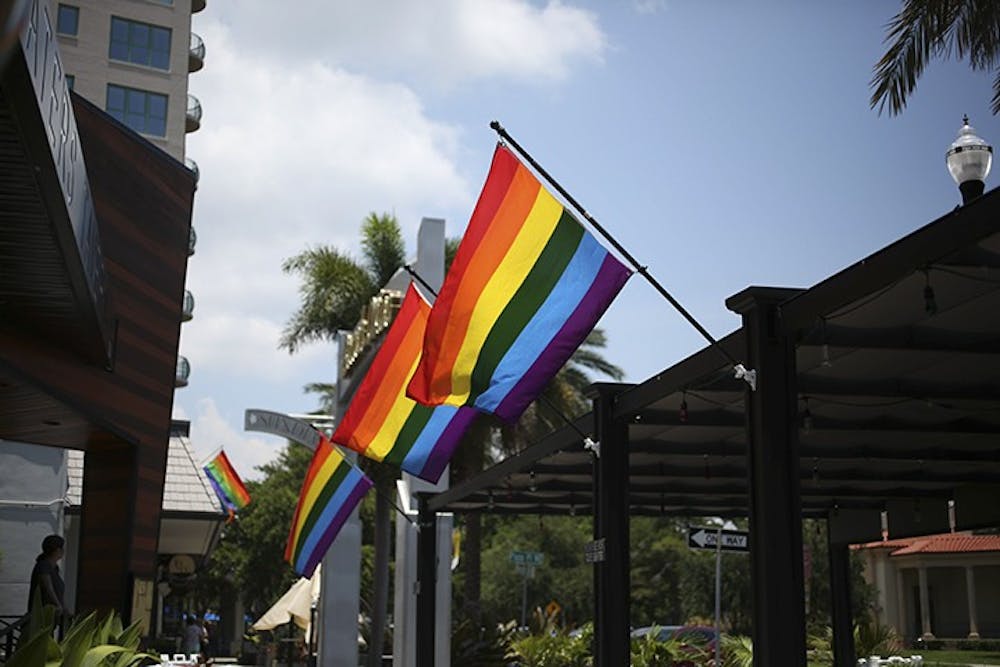 Rainbow flags fly in front of St. Petersburg businesses in preparation for the 2018 Pride parade. On Saturday, a block-long rainbow flag will be unfurled during the Come Out St. Pete Parade. Martha Asencio Rhine  |  Times