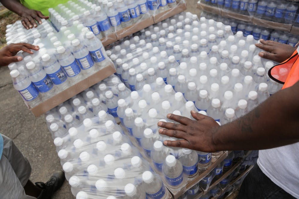 Workers wait to hand out water to Flint residents from a Community Point of Distibution site at St. Mark Missionary Baptist Church in Flint's north side on Friday, Aug. 5, 2016. (Ryan Garza/Detroit Free Press/TNS) 