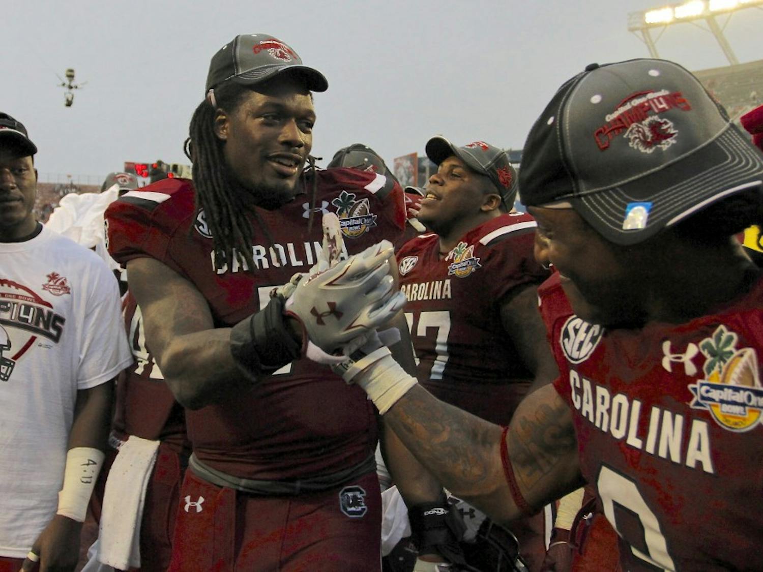 	Junior defensive end Jadeveon Clowney celebrates his last win at South Carolina with teammate Sharrod Golightly at the Capital One Bowl on Jan. 1.