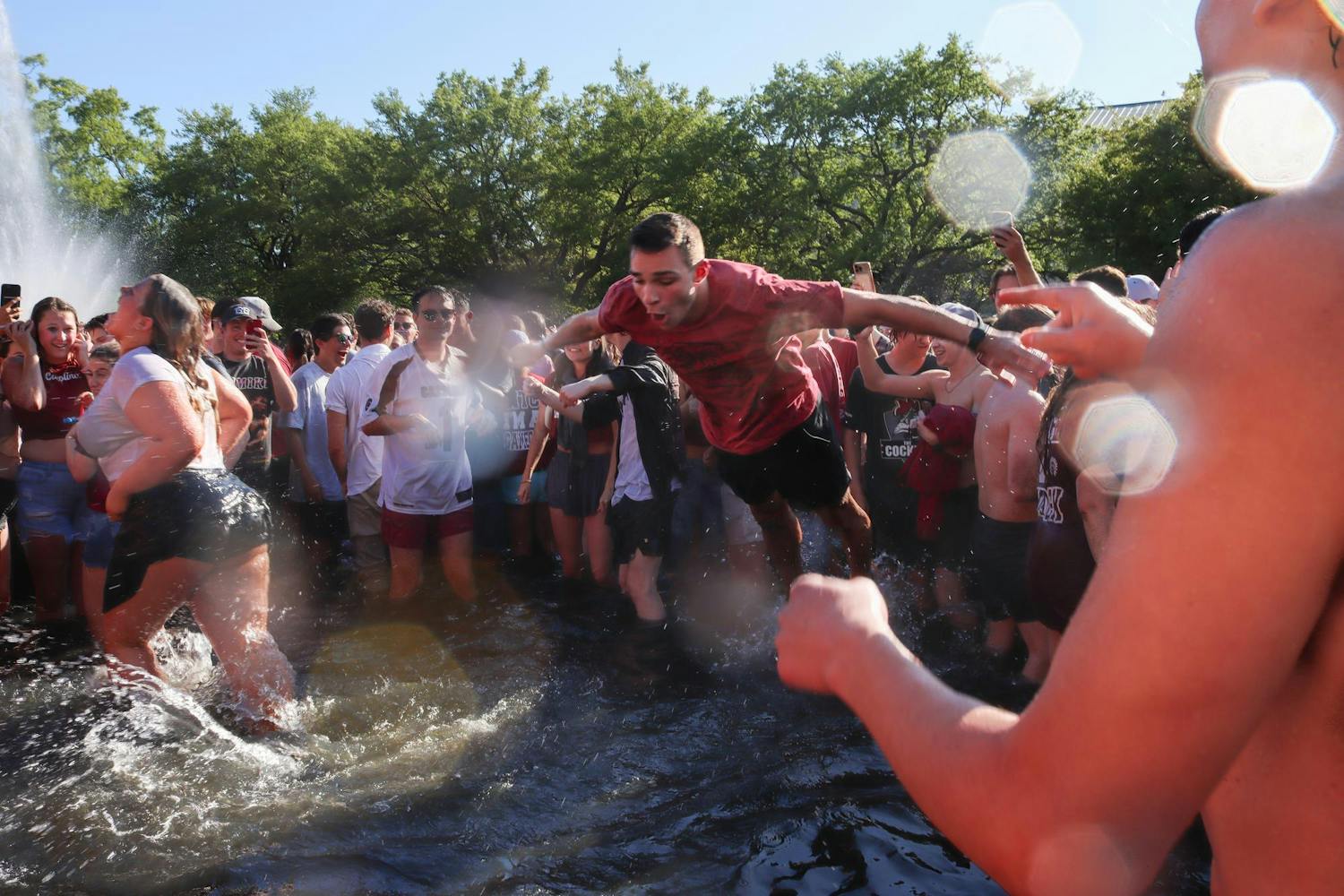 A student at the University of South Carolina belly flops into the Thomas Cooper Reflecting Pool after the women's basketball National Championship win on April 7, 2024. The Gamecocks had a comeback win after suffering from an 11-point Iowa Hawkeyes lead.