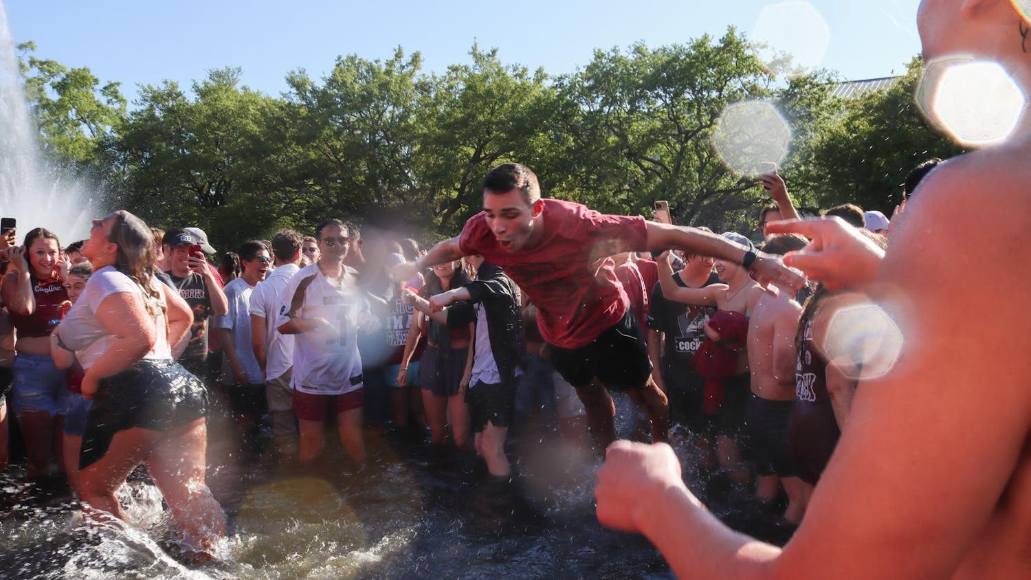 A student at the University of South Carolina belly flops into the Thomas Cooper Reflecting Pool after the women's basketball National Championship win on April 7, 2024. The Gamecocks had a comeback win after suffering from an 11-point Iowa Hawkeyes lead.