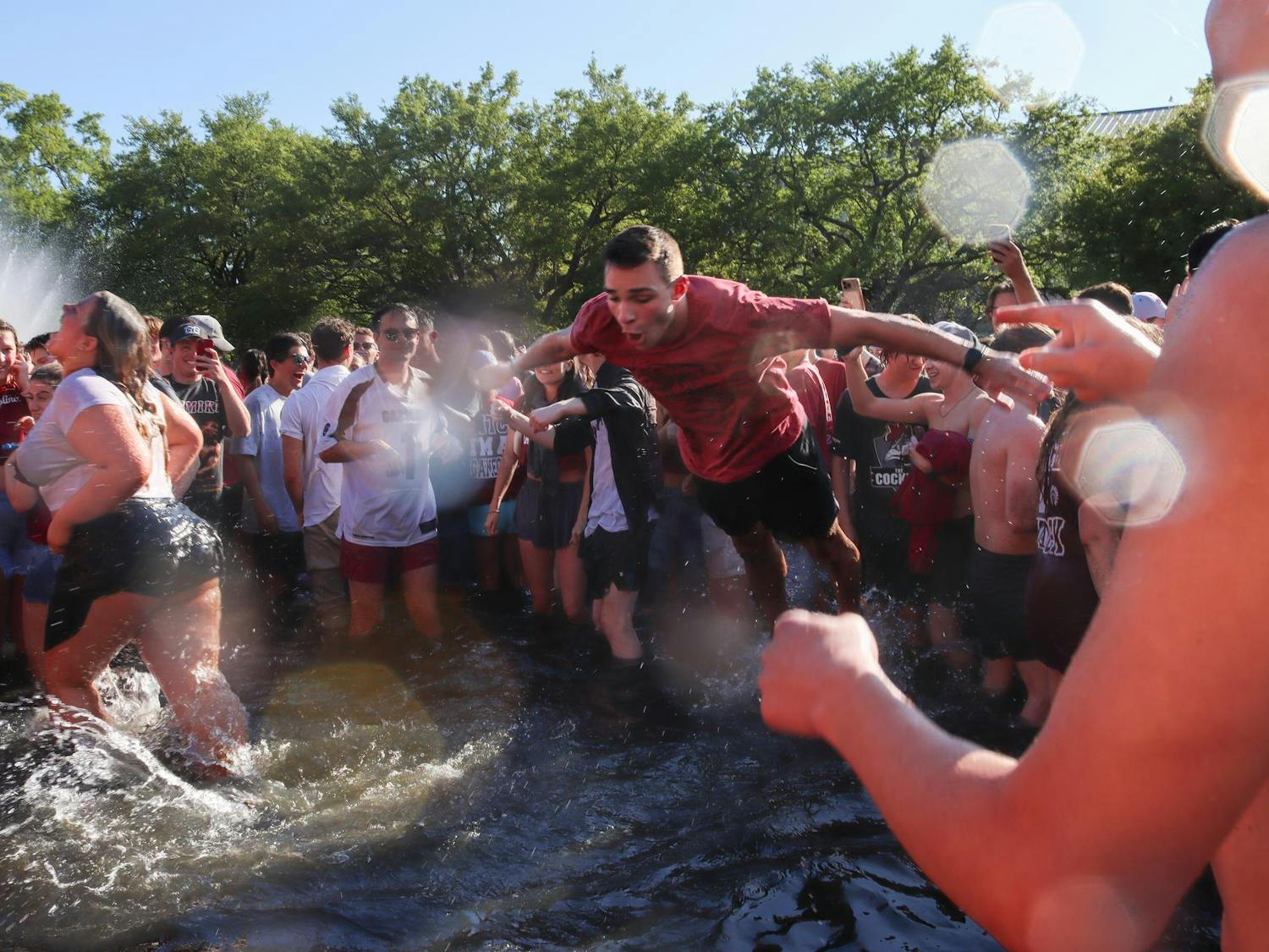A student at the University of South Carolina belly flops into the Thomas Cooper Reflecting Pool after the women's basketball National Championship win on April 7, 2024. The Gamecocks had a comeback win after suffering from an 11-point Iowa Hawkeyes lead.