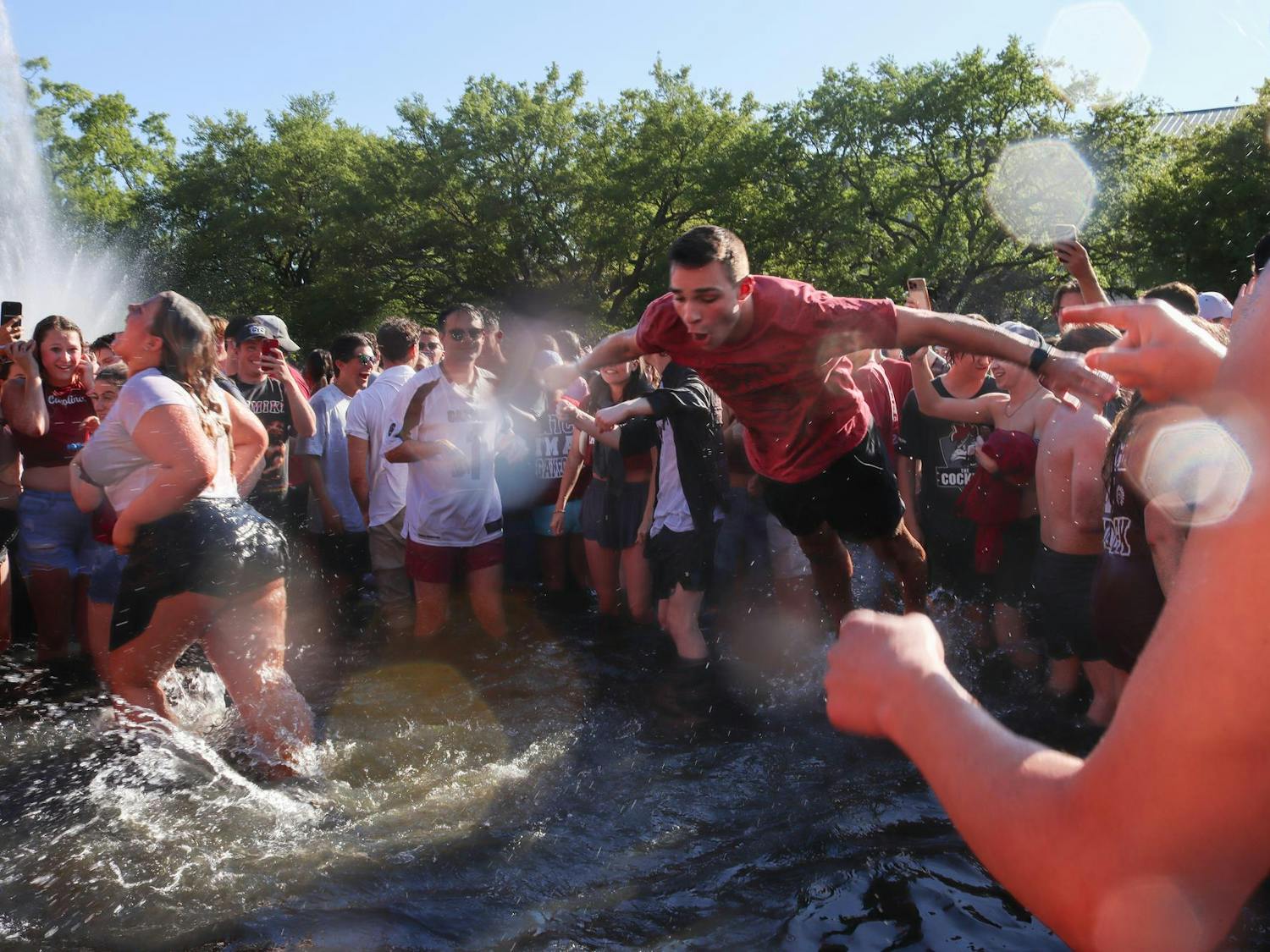 A student at the University of South Carolina belly flops into the Thomas Cooper Reflecting Pool after the women's basketball National Championship win on April 7, 2024. The Gamecocks had a comeback win after suffering from an 11-point Iowa Hawkeyes lead.