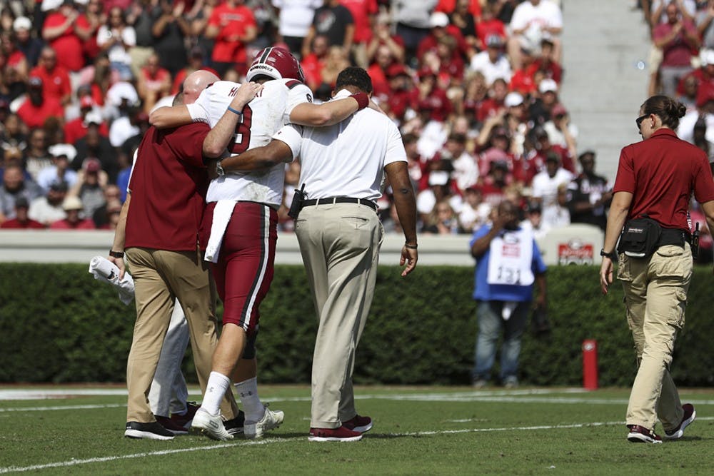 Freshman quarterback Ryan Hilinski is helped off the field after a knee injury during the third quarter.
