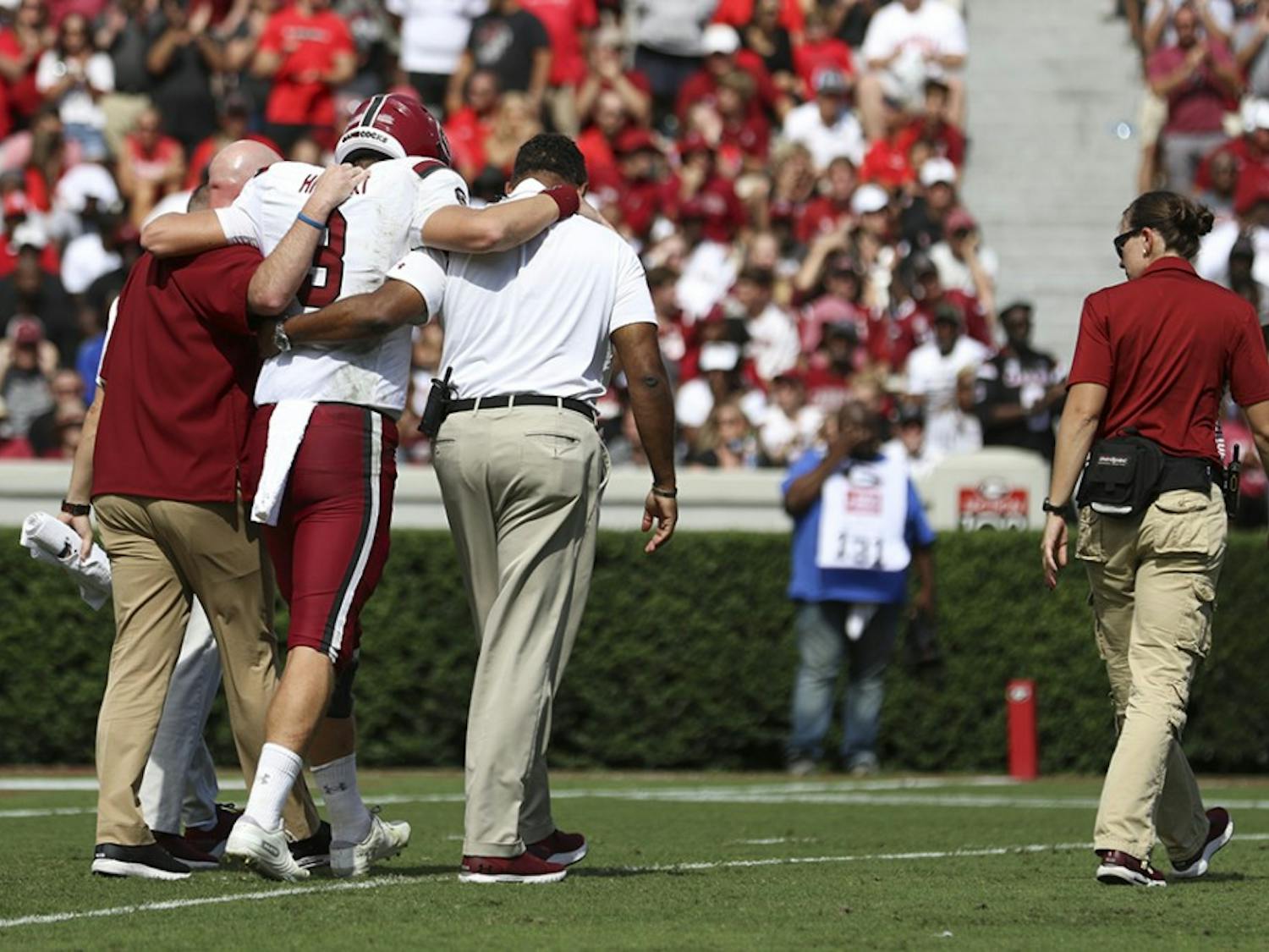 Freshman quarterback Ryan Hilinski is helped off the field after a knee injury during the third quarter.