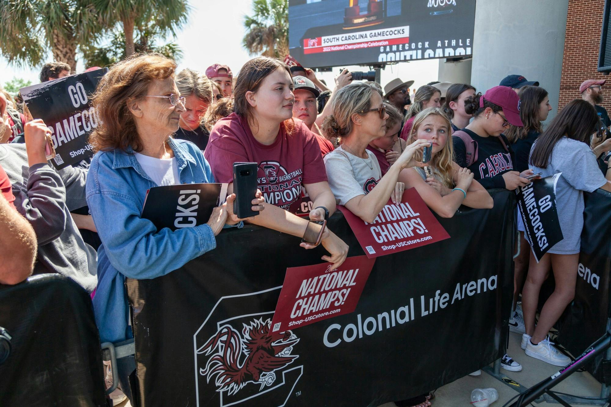 South Carolina fans take photos and hold signs at Colonial Life Arena in Columbia, SC on April 4, 2022. Fans waited for the team's arrival outside of the main entrance.