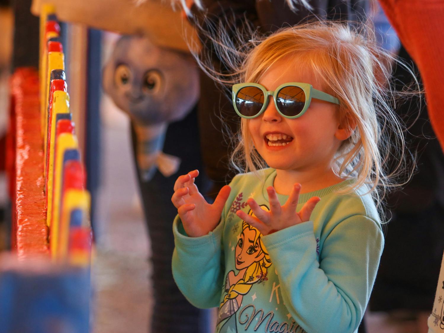 A young girl accompanied by her family enjoys the South Carolina State Fair's petting zoo on Oct. 18, 2022. Over the primary colored fence were animals that brought about excited reactions like hers. 