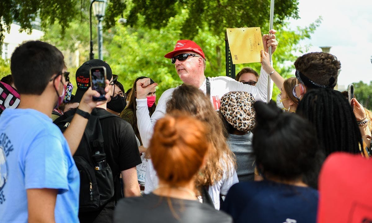 Jim Gilles preaches to students protesting his presence on Greene Street Friday, Aug. 21. Pictured is him saying, “I see the intelligence level getting lower and lower,” after a student tried to reason with him.