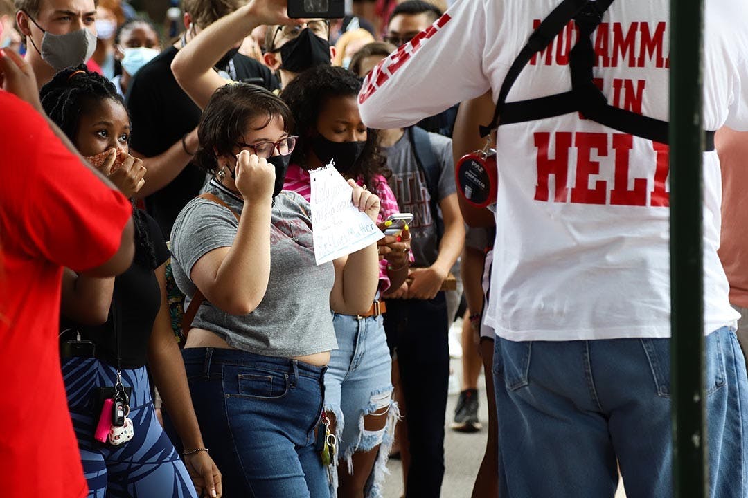 A student dancing while holding an “’Only justice will bring peace’- Avatar Kyoshi Black Lives Matter” sign. 