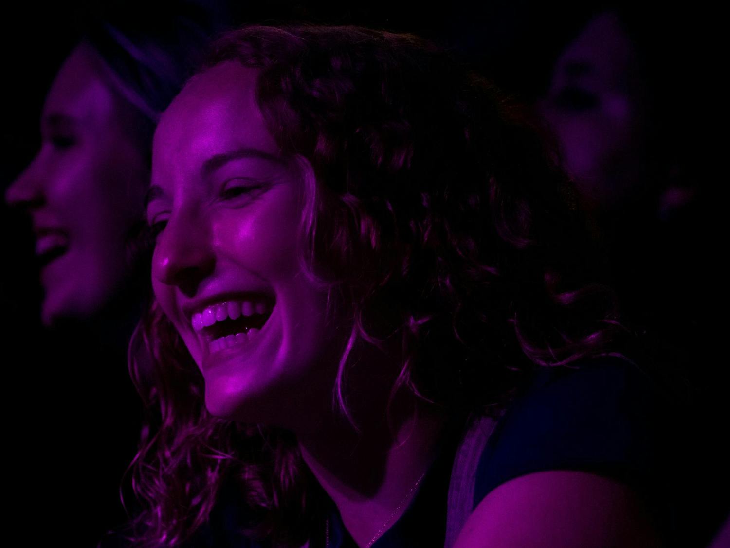 First-year nursing student Shannon Deutsch smiles while The Third Floor's performs at Cockstock. The Third Floor's performance included a cover of "Valerie" by Amy Winehouse that excited many concertgoers.