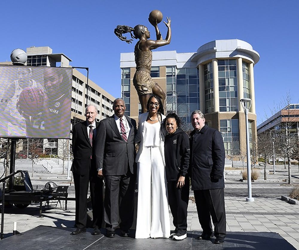A'ja Wilson standing with Dawn Staley and others in front of her statue that was unveiled in front of Colonial Life Arena on Monday, Jan. 18 2021.