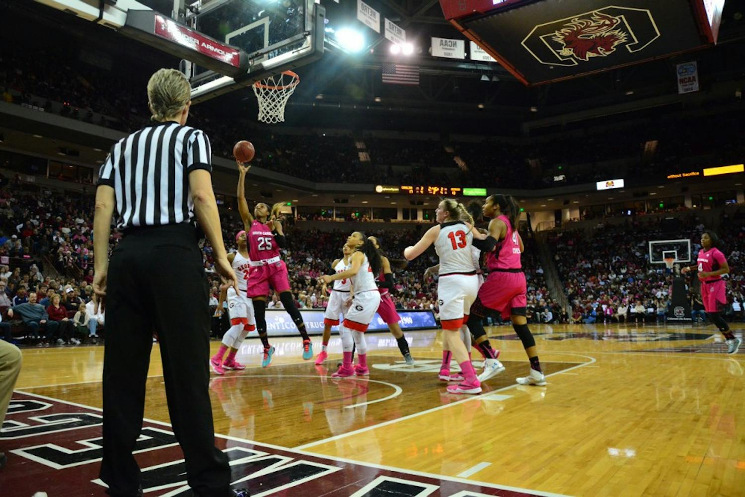 Tiffany Mitchell (25) of the South Carolina Gamecocks gets the ball out of the Georgia Bulldogs' reach long enough to score her first-of-many two-pointers during the first quarter. South Carolina Gamecocks vs Georgia Bulldogs. Colonial Life Arena, Columbia, SC. February 18, 2016