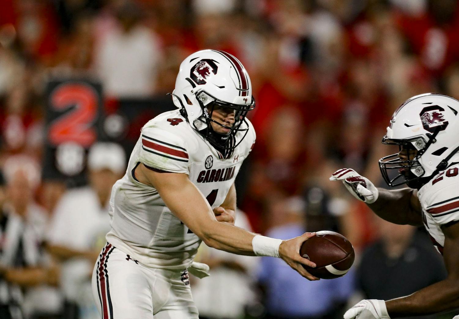 Sophomore quarterback Luke Doty hands the ball off to running back Kevin Harris in South Carolina's game against Georgia on Sept. 18, 2021.
