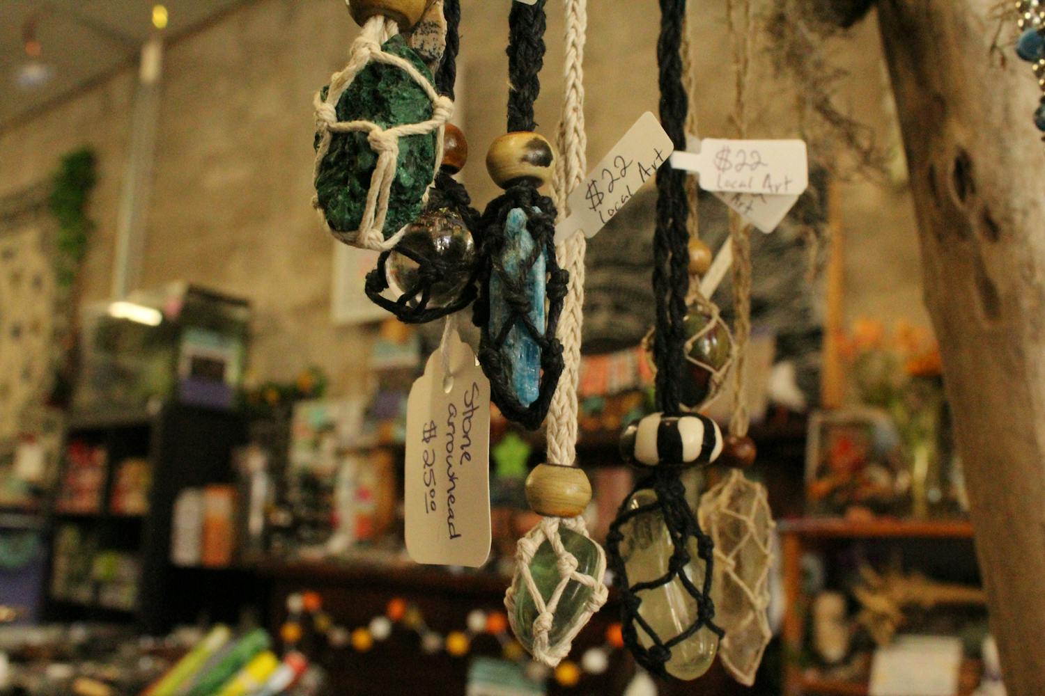A few crystals hang from a tree at The Witching Hour on Oct. 4, 2023. Customers of the witchcraft store said they have enjoyed its mission to remove the stigma surrounding magic.