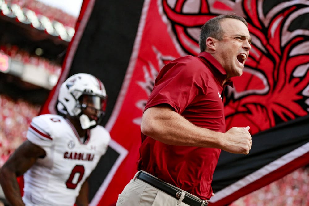 <p>FILE—Head coach Shane Beamer runs out on the field before warm-ups during South Carolina’s game against Georgia on Sept. 18, 2021. The Gamecocks lost 40-13. &nbsp;</p>