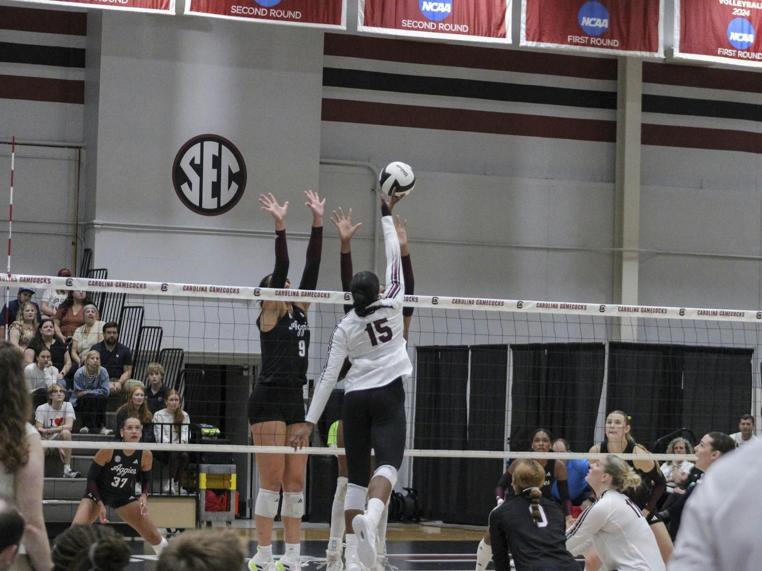 Junior outside hitter Nia Hall tips the ball over the hands of two Texas A&M players on Oct. 1, 2025, at the Carolina Volleyball Center. The Gamecocks lost the match 1-3.