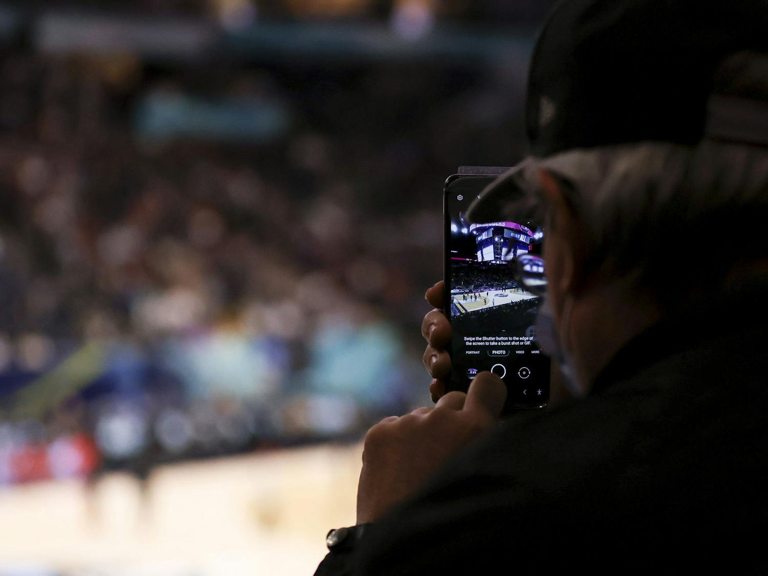 Fan takes a photo of South Carolina's open practice in the Target Center on Saturday, April 2, 2022.