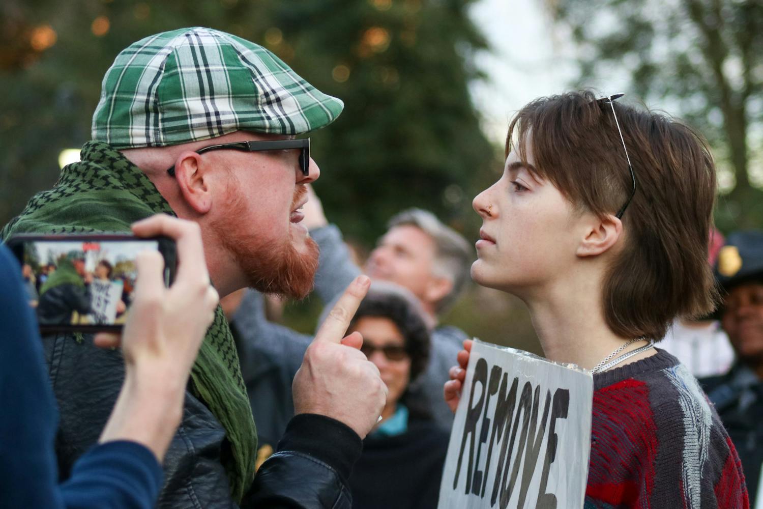 Attendee JT Bessinger (left) and protestor and third-year media arts student Katelynn Basile (right) engage in a verbal altercation with each other at the Statehouse on Jan. 28, 2023. A crowd gathered outside of the Statehouse on Saturday as former President Donald Trump spoke inside to invitees and members of the media.