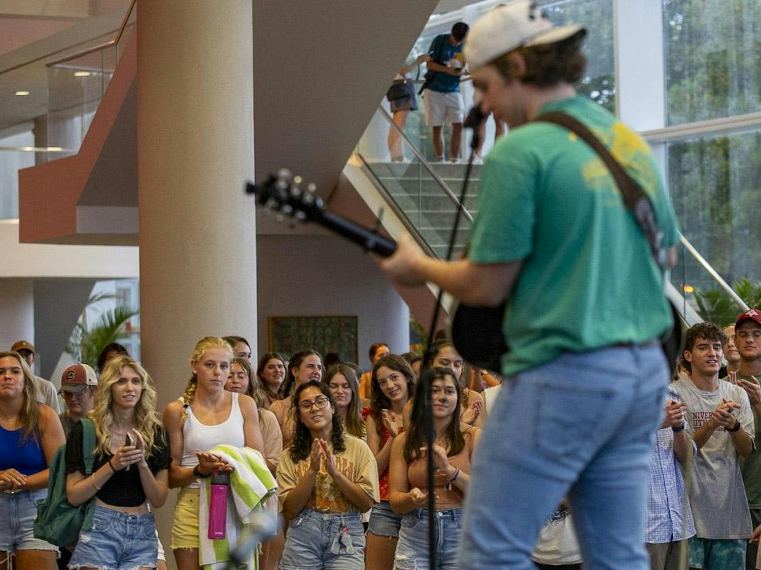 Students clap during country artist Vincent Mason's performance at the Koger Center on Aug. 27, 2023. Mason has been writing music for four years and has been performing in Nashville, Tenn., for the past three years.