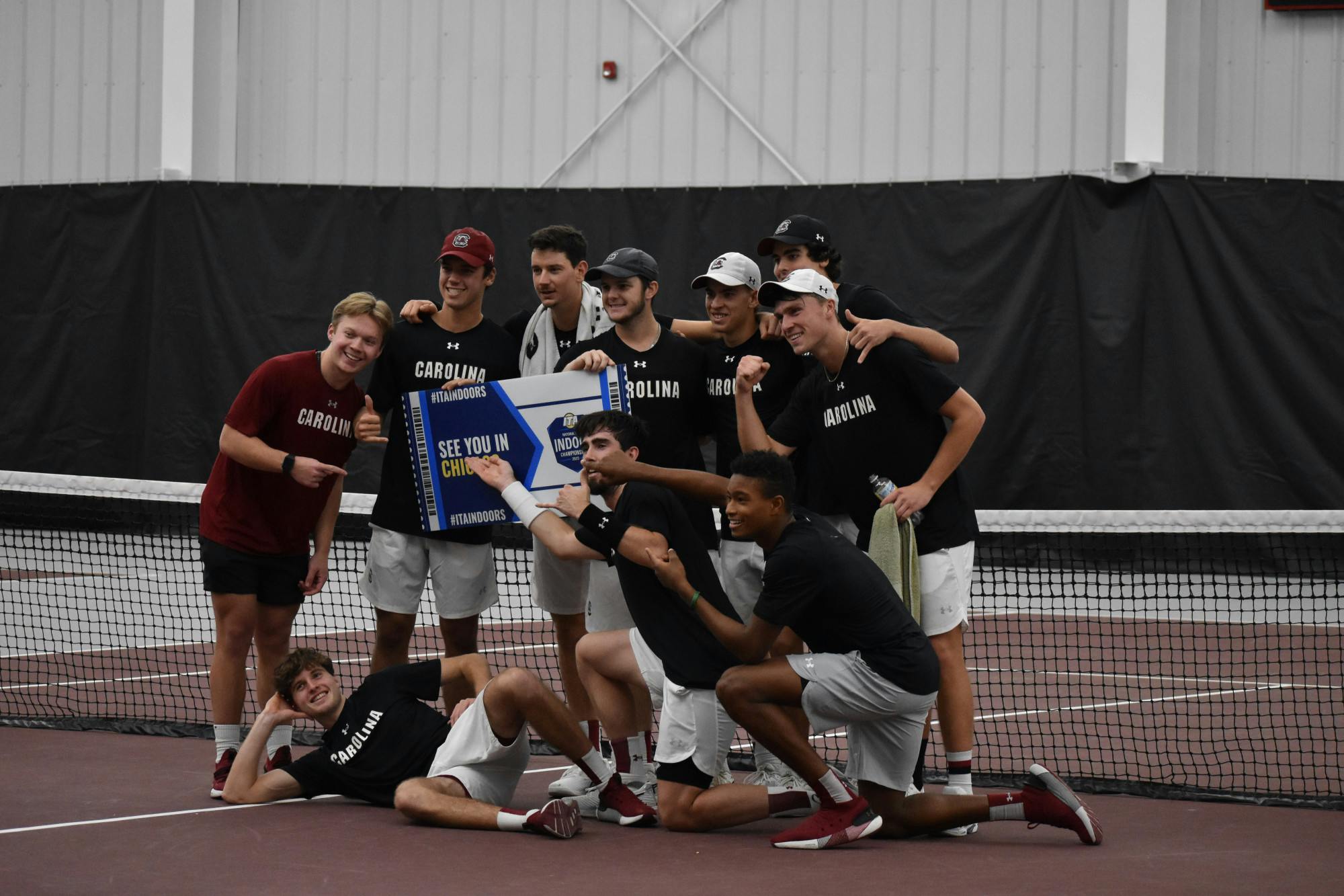 South Carolina’s men’s tennis team poses together with the ITA tournament sign after winning the ITA Kickoff Weekend event at the Carolina Indoor Tennis Center on Jan. 29, 2023. The South Carolina Gamecocks beat N.C. State 4-0.&nbsp;
