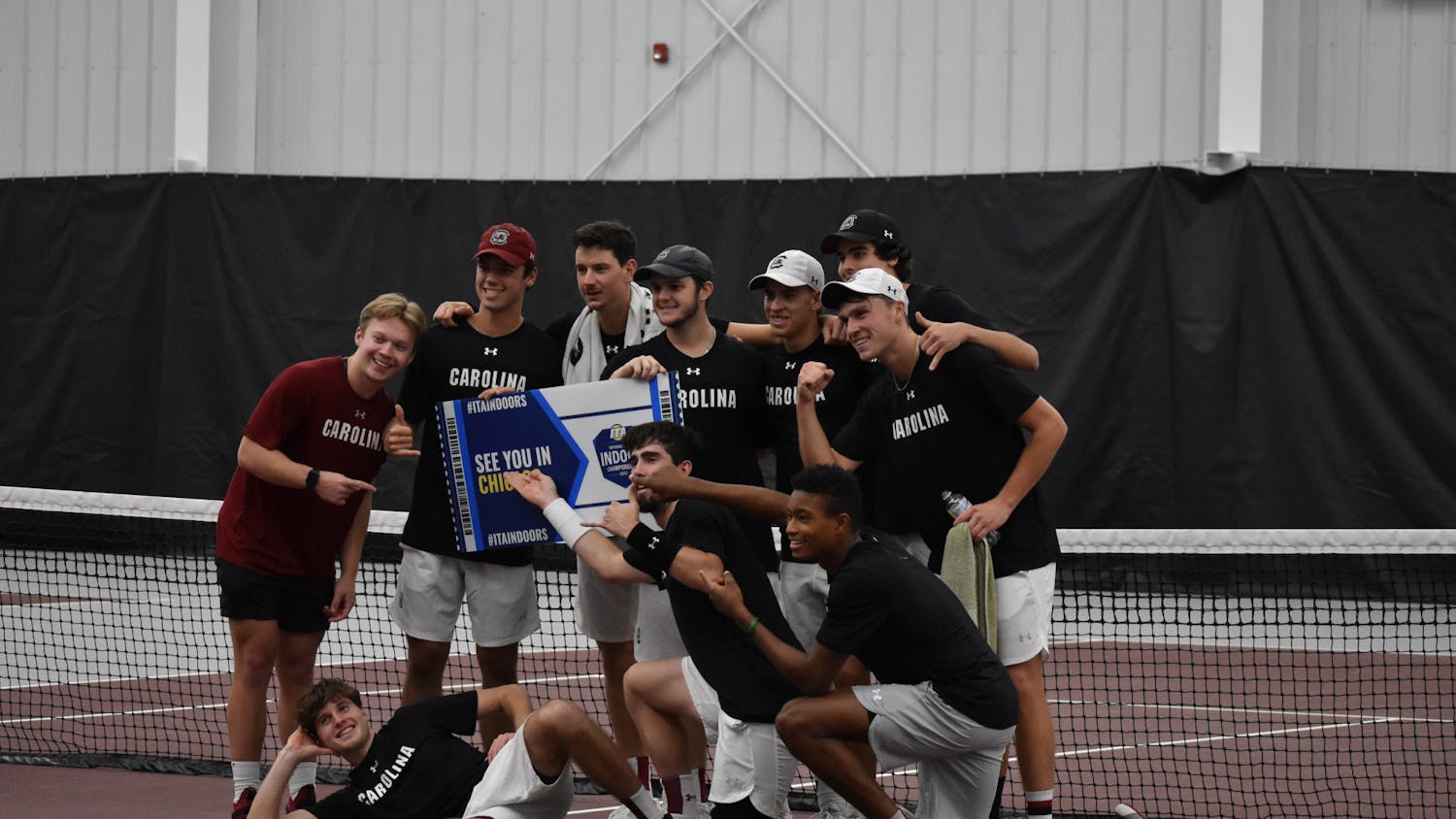 South Carolina’s men’s tennis team poses together with the ITA tournament sign after winning the ITA Kickoff Weekend event at the Carolina Indoor Tennis Center on Jan. 29, 2023. The South Carolina Gamecocks beat N.C. State 4-0.&nbsp;