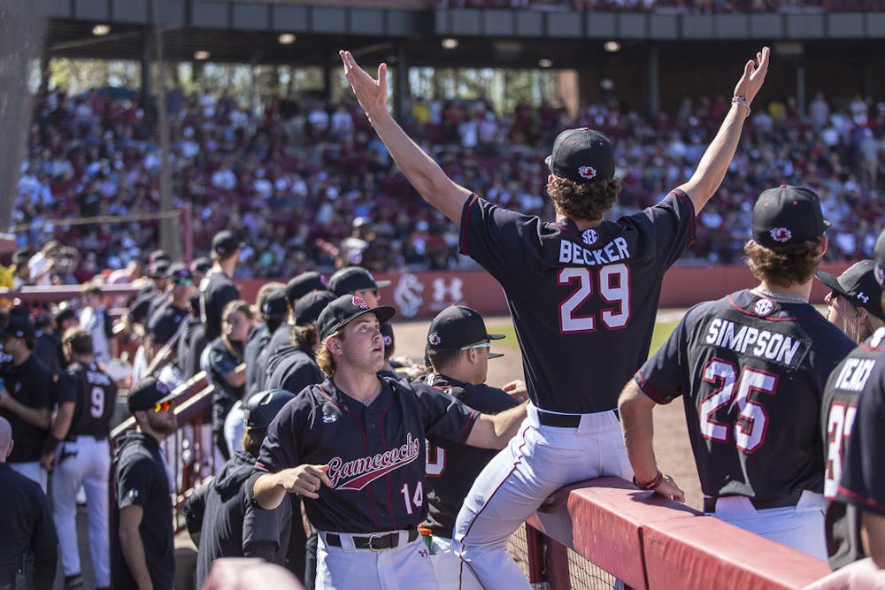 <p>FILE—Sophomore pitchers Eli Jones (left) and Matthew Becker (right) cheer with their teammates after a South Carolina batter walks in the first inning against Clemson on March 5, 2023. The Gamecocks beat the Tigers 7-1.</p>