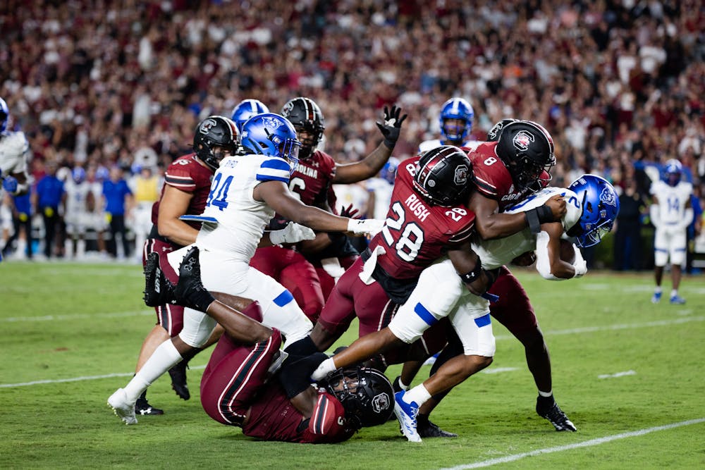 <p>FILE- Redshirt senior defensive back Darius Rush and graduate student running back Christian Beal-Smith tackle a Georgia State wide receiver Jamari Thrash as he makes his way toward the end zone. The Gamecocks meet the Gators this weekend in Florida.</p>