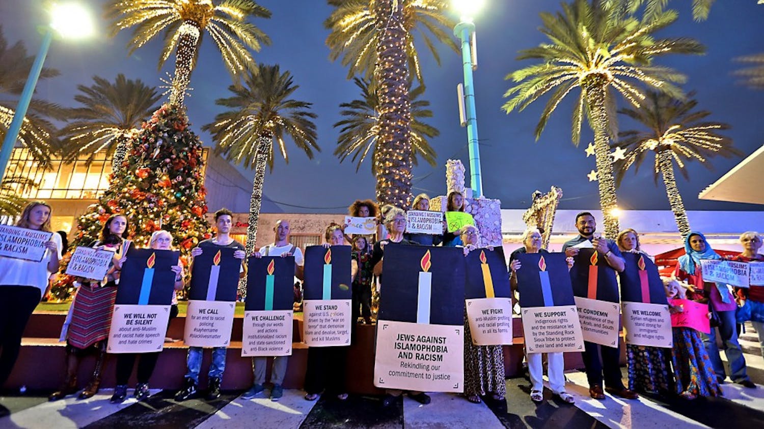 A group gathered on Wednesday, Dec. 21, 2016 on Lincoln Road on Miami Beach in Florida, making a commitment to fighting Islamophobia and racism. (Patrick Farrell/Miami Herald/TNS)