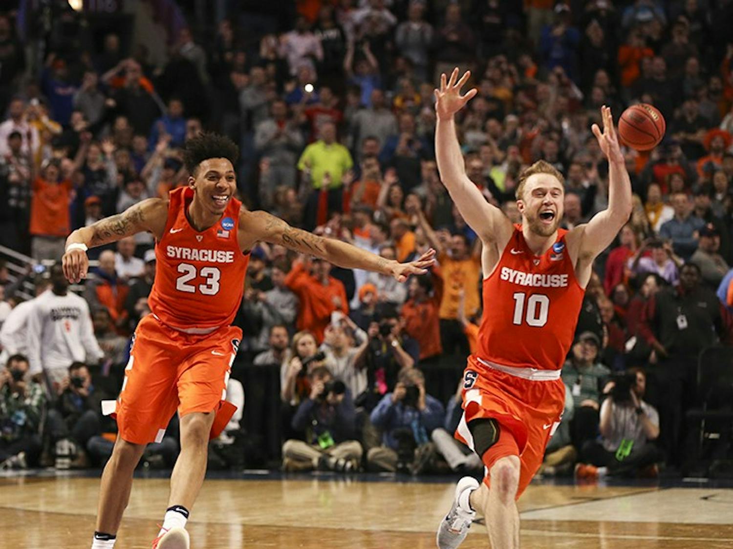 Syracuse Orange guard Malachi Richardson (23) and Syracuse Orange guard Trevor Cooney (10) celebrate at the end of their team's 68-62 win over the Virginia Cavaliers on Sunday, March 27, 2016, at the United Center in Chicago. (Nuccio DiNuzzo/Chicago Tribune/TNS)
