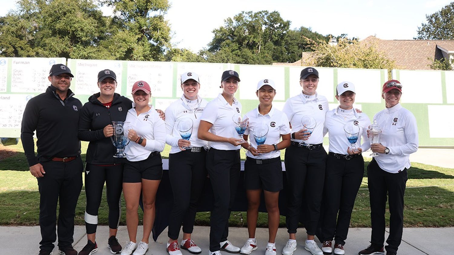 FILE — South Carolina 2021 women's golf team with trophies after the Landfall Tradition Tournament. The team finished its season with two wins, as the No. 3 team in the country and is currently training for the spring season.