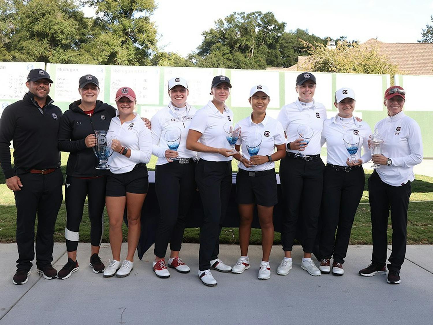 FILE — South Carolina 2021 women's golf team with trophies after the Landfall Tradition Tournament. The team finished its season with two wins, as the No. 3 team in the country and is currently training for the spring season.