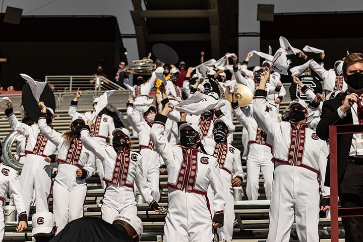 Masked members of the Carolina Band cheer on the Gamecocks. The band has had to make changes in order to stay safe during the COVID-19 pandemic.&nbsp;