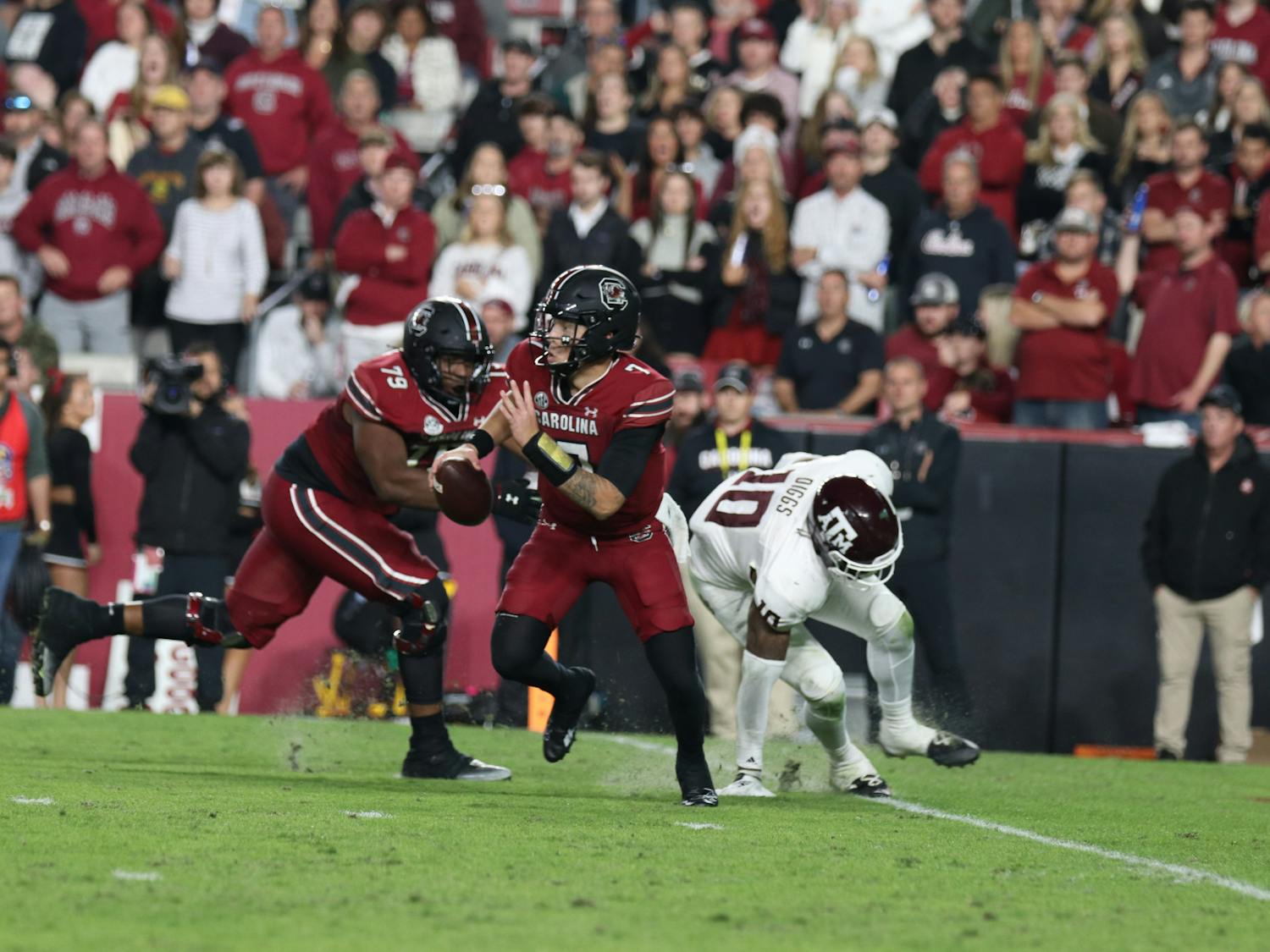 FILE — Redshirt junior quarterback Spencer Rattler scrambles out of the pocket while looking downfield for open receivers in the fourth quarter against the Texas A&M Aggies at Williams-Brice Stadium on Oct. 22, 2022. The Gamecocks defeated the Aggies 30-24. 