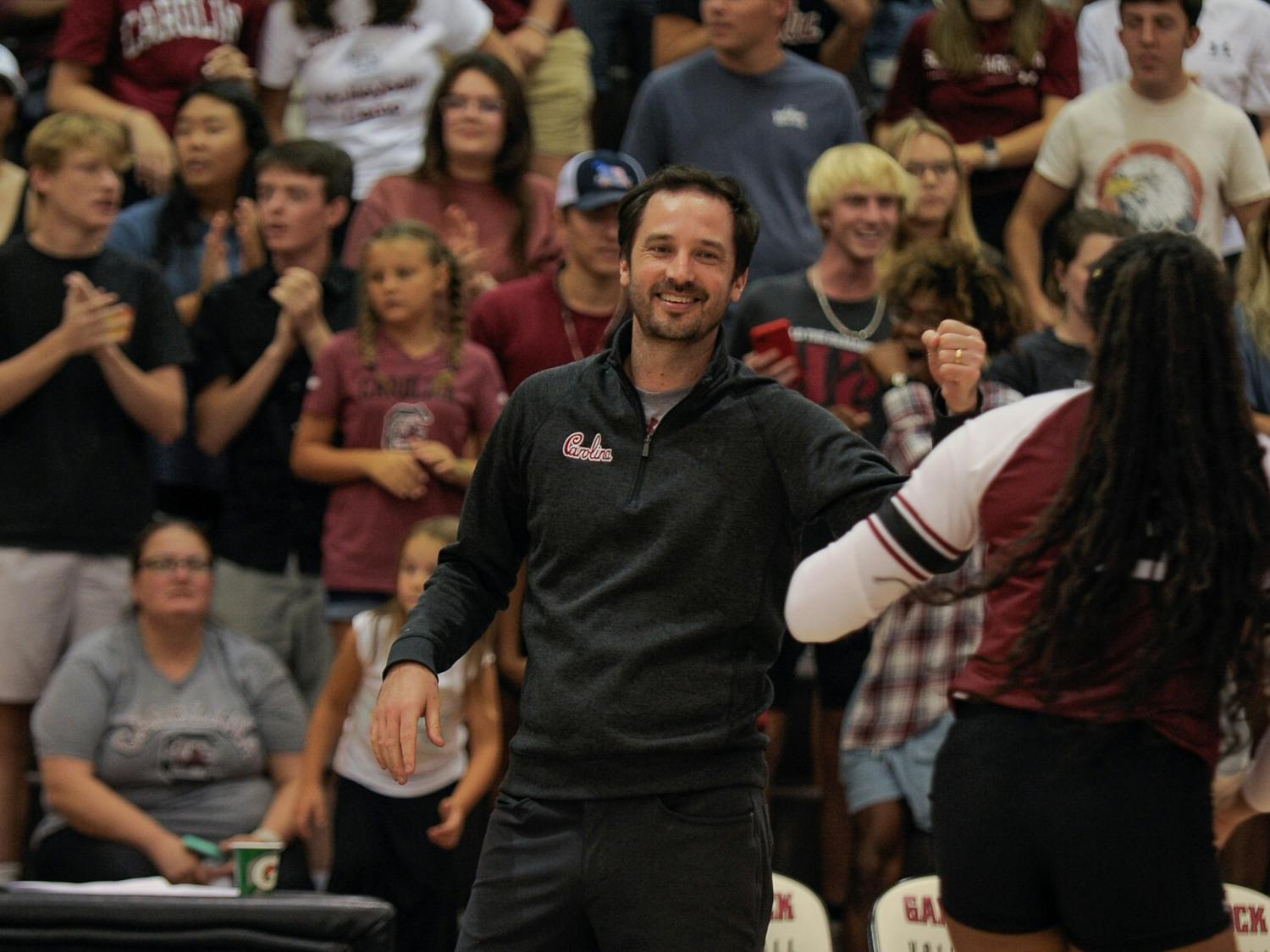 South Carolina head volleyball coach Tom Mendoza fist bumps sophomore Oby Anadi with a smile during the Carolina Classic on August 27, 2022 at the Carolina Volleyball Center.