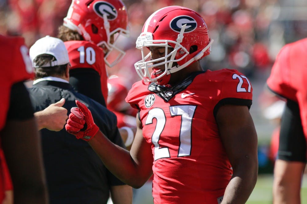 Georgia tailback Nick Chubb (27) fist bumps a teamate during pre-game warmups before the start of Georgia's regular season game versus the University of Tennessee at Sanford Stadium on Oct. 1, 2016 in Athens, Ga. (Photo/Thomas Mills)