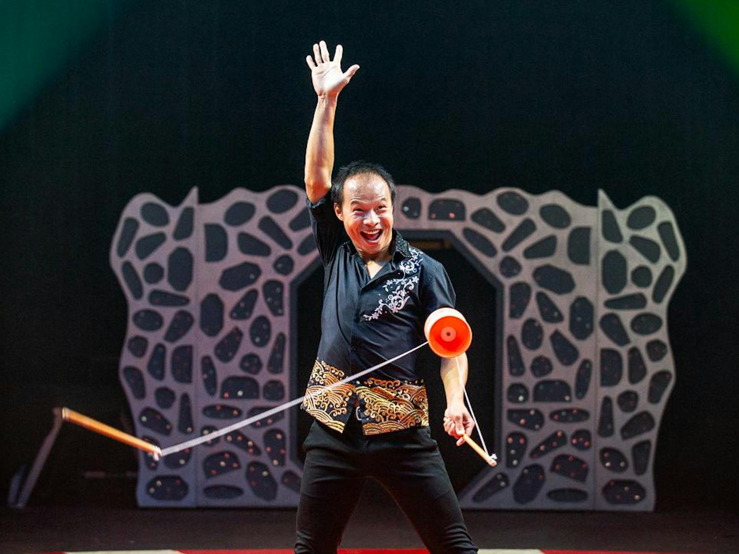 Diabolo artist Chu Chuan-Ho greets the audience during his performance at the CIRCUS at the Fair on Oct. 18, 2023. Diabolo is a juggling act in which the performer uses a pair of sticks and a string to juggle, toss and catch the diabolo, a pair of cups connected by an axle.