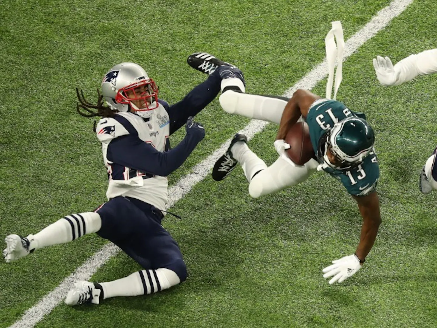 Philadelphia Eagles wide receiver Nelson Agholor (13) falls forward during the Eagles' first drive as Stephon Gilmore, left, and Kyle Van Noy defend in Super Bowl LII on Sunday, Feb. 4, 2018 in Minneapolis, Minn. (Elizabeth Flores/Minneapolis Star Tribune/TNS)