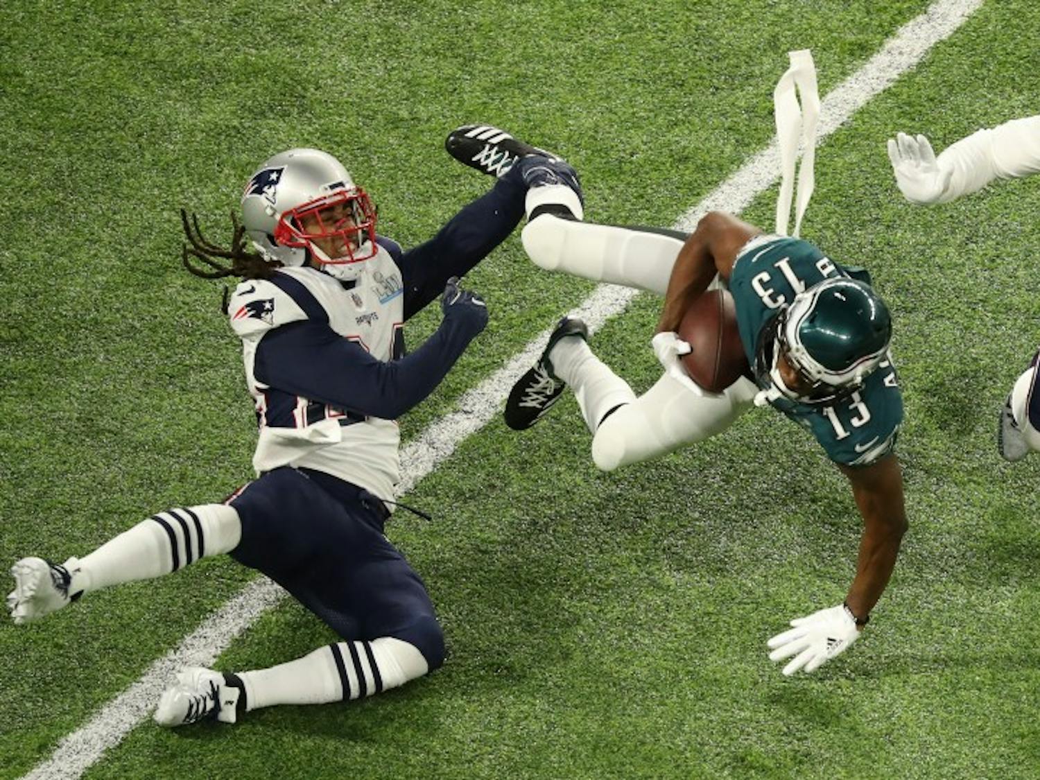 Philadelphia Eagles wide receiver Nelson Agholor (13) falls forward during the Eagles' first drive as Stephon Gilmore, left, and Kyle Van Noy defend in Super Bowl LII on Sunday, Feb. 4, 2018 in Minneapolis, Minn. (Elizabeth Flores/Minneapolis Star Tribune/TNS) 