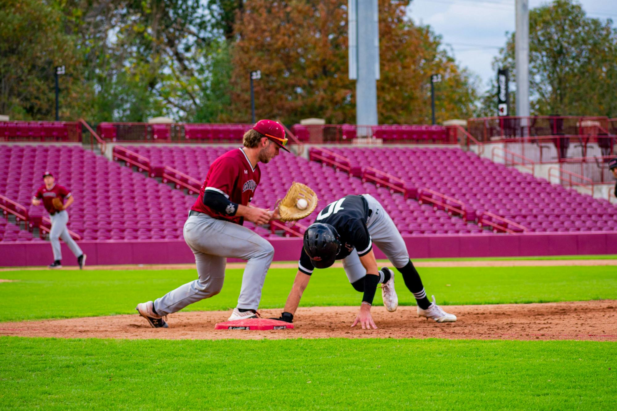 Sophomore catcher/infielder Cole Messina attempts to pick off transfer outfielder Dylan Brewer at first base during an intrasquad scrimmage on Nov. 2, 2022. Messina and the Garnet team went on to win the three game Garnet and Black World Series later in the week.