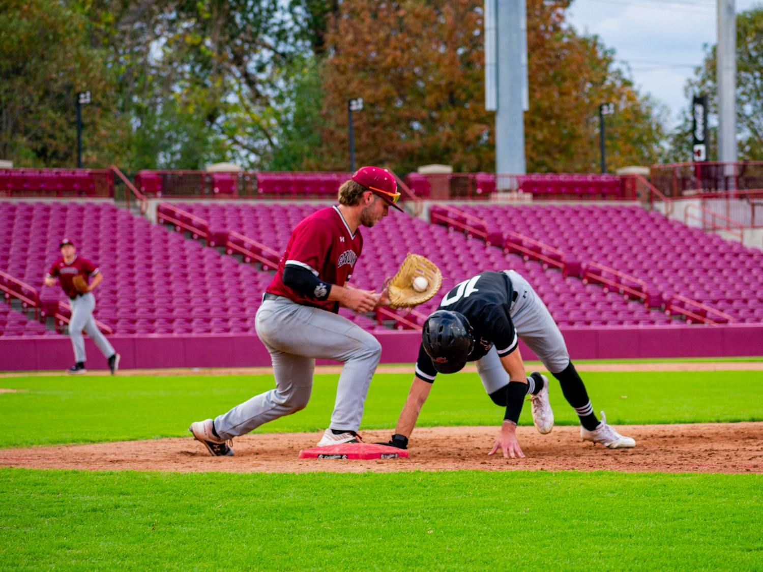 Sophomore catcher/infielder Cole Messina attempts to pick off transfer outfielder Dylan Brewer at first base during an intrasquad scrimmage on Nov. 2, 2022. Messina and the Garnet team went on to win the three game Garnet and Black World Series later in the week.