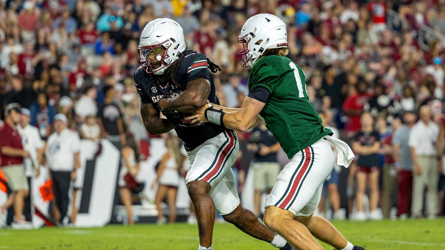 FILE — Freshman quarterback Cutter Woods fakes a handoff to graduate running back Rahsul Faison during the spring football game at Williams-Brice Stadium on April 18, 2025. Faison has been granted an additional year of eligibility from the NCAA, allowing him to play for the Gamecocks this year.