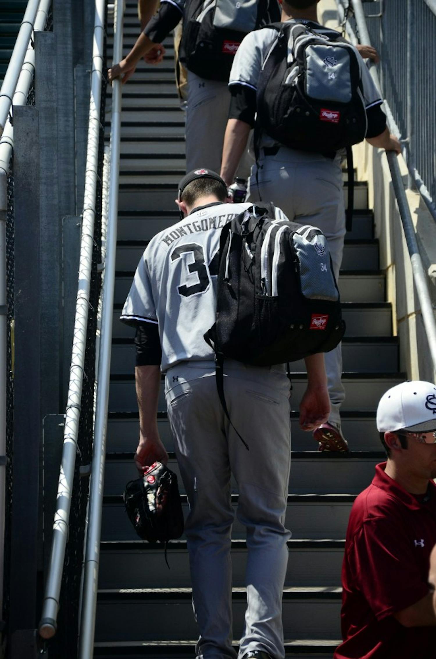 Jordan Montgomery, who led the Gamecocks to a victory in their second game, exits the stadium with his teammates.